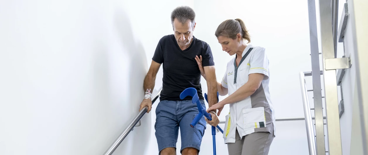 verpleegkundige en patient aan trap